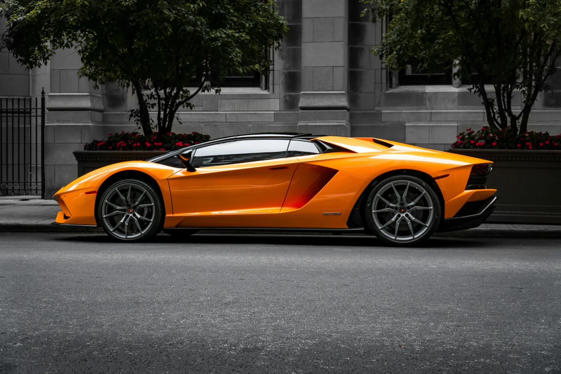 Orange Lamborghini photographed in profile on a city street